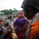 Migrants climb onboard a truck to get a ride to Cordoba from Isla, Mexico, on Nov. 4.